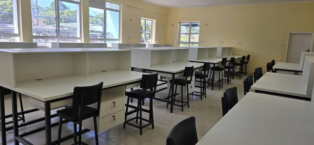 Fitted study carrels with white desk tops, upper hutches and matching stools.